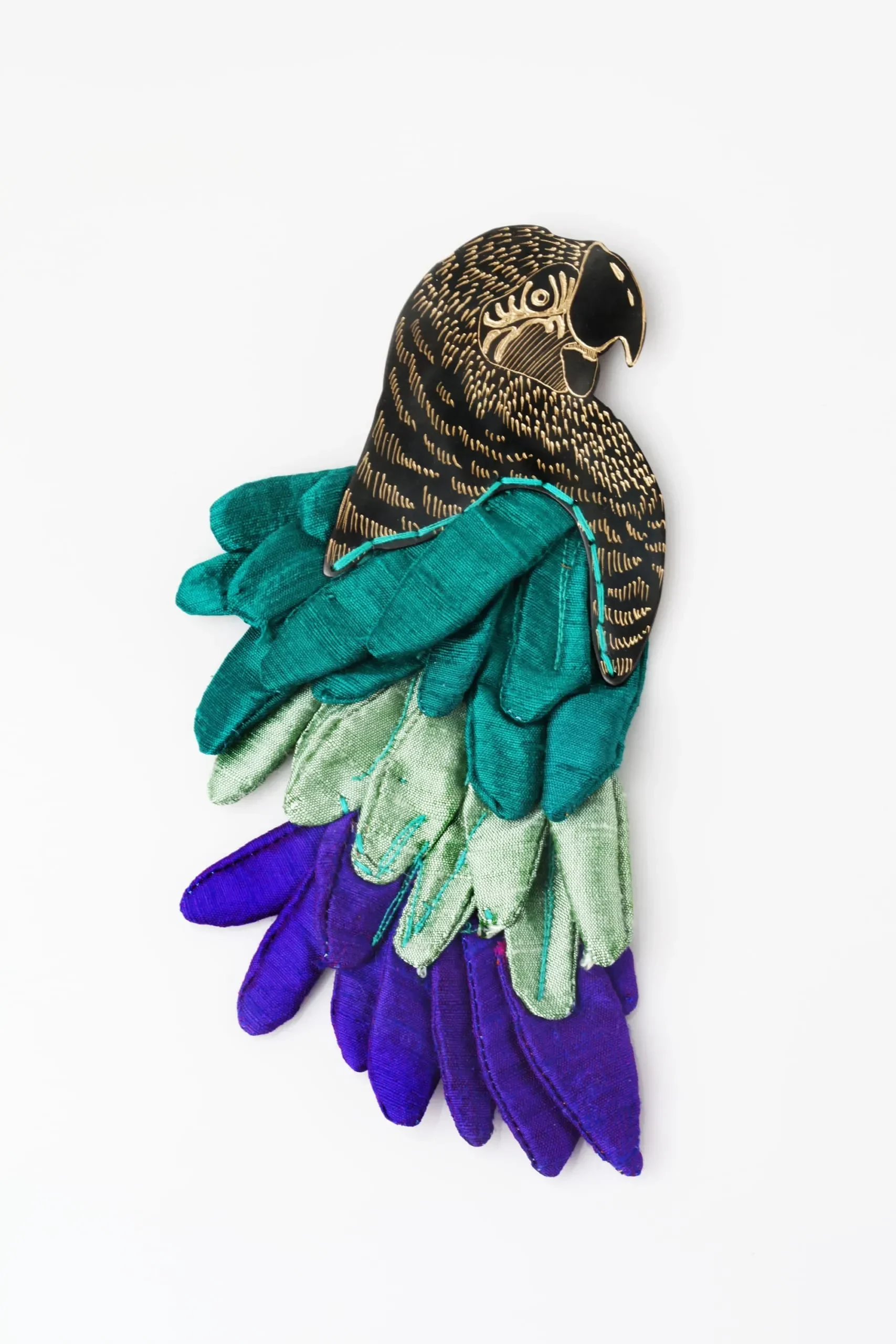 Parrot engraved bronze brooch with silk fabric