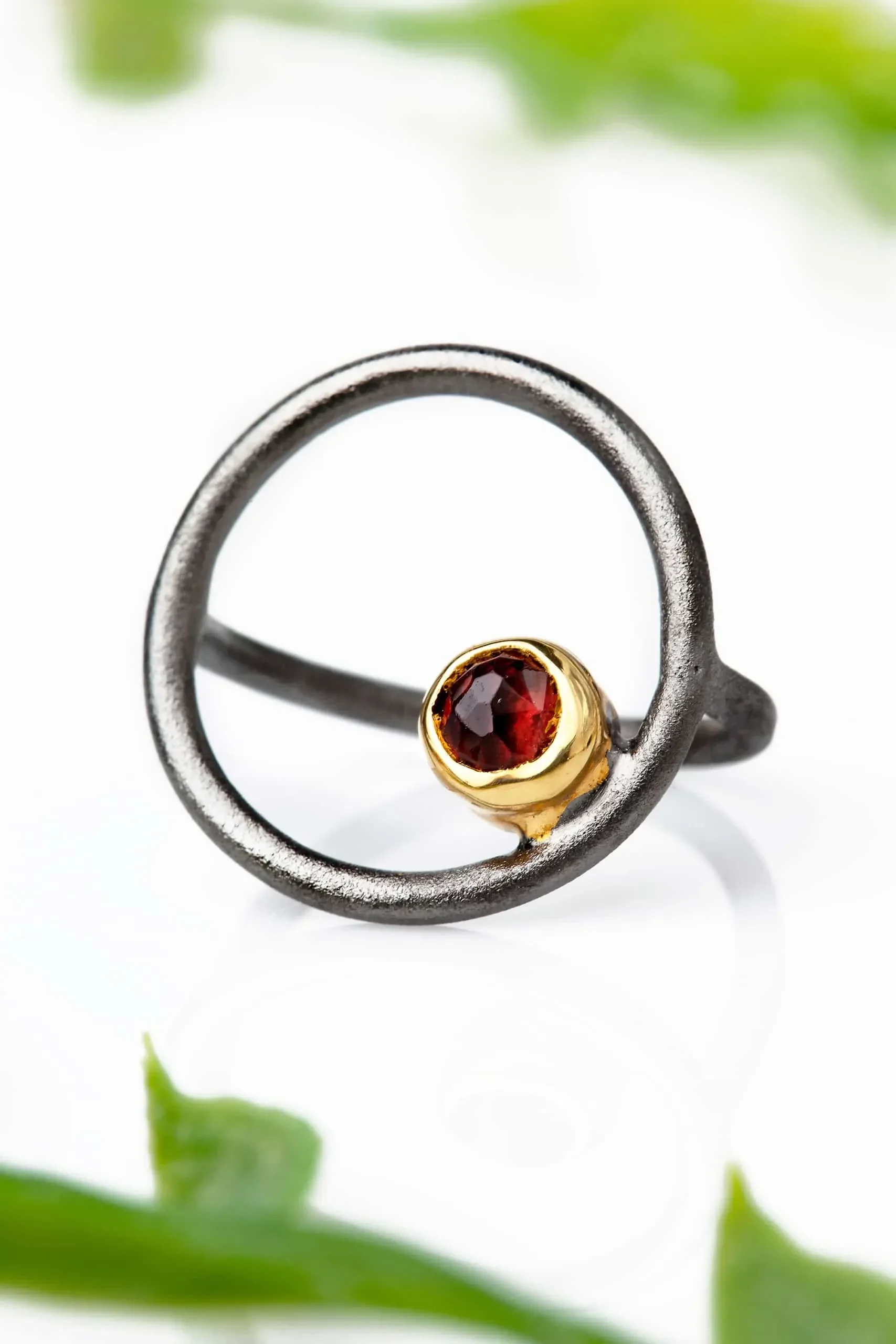 Handmade Jewellery | Round black rhodium plated silver ring with garnet gallery 1