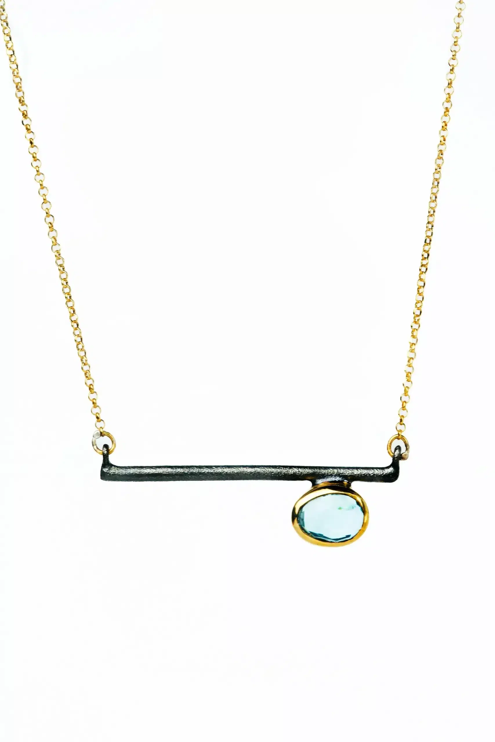 Handmade Jewellery | Gold and black rhodium plated silver necklace with blue topaz main