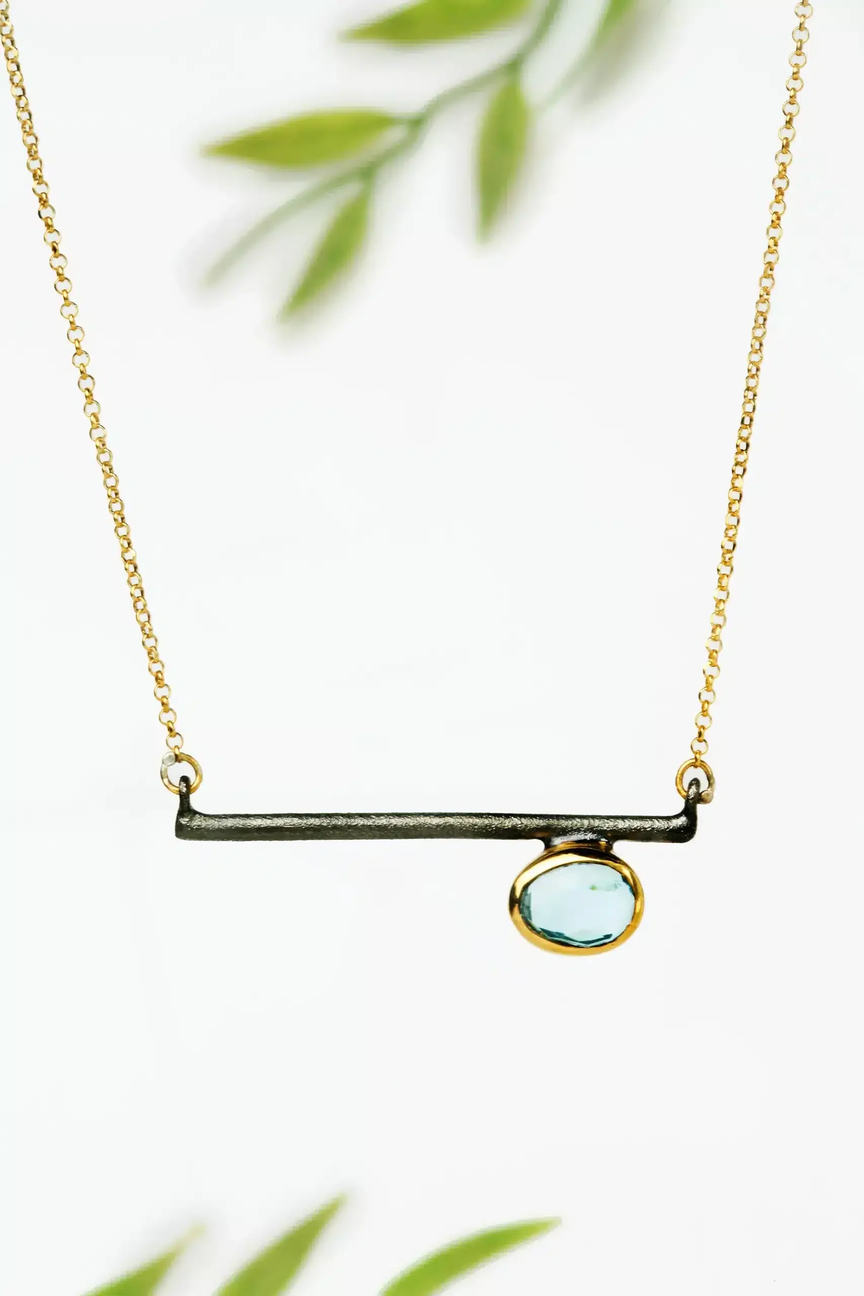 Handmade Jewellery | Gold and black rhodium plated silver necklace with blue topaz gallery 1