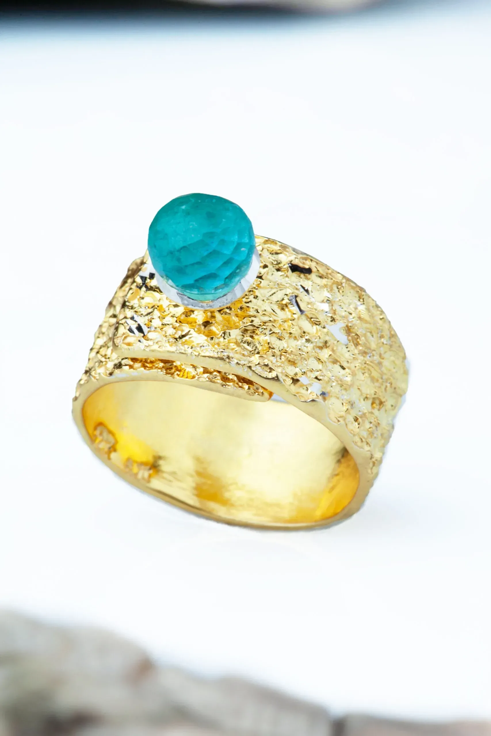 Handmade Jewellery | Gold plated textured silver ring with blue crystal main