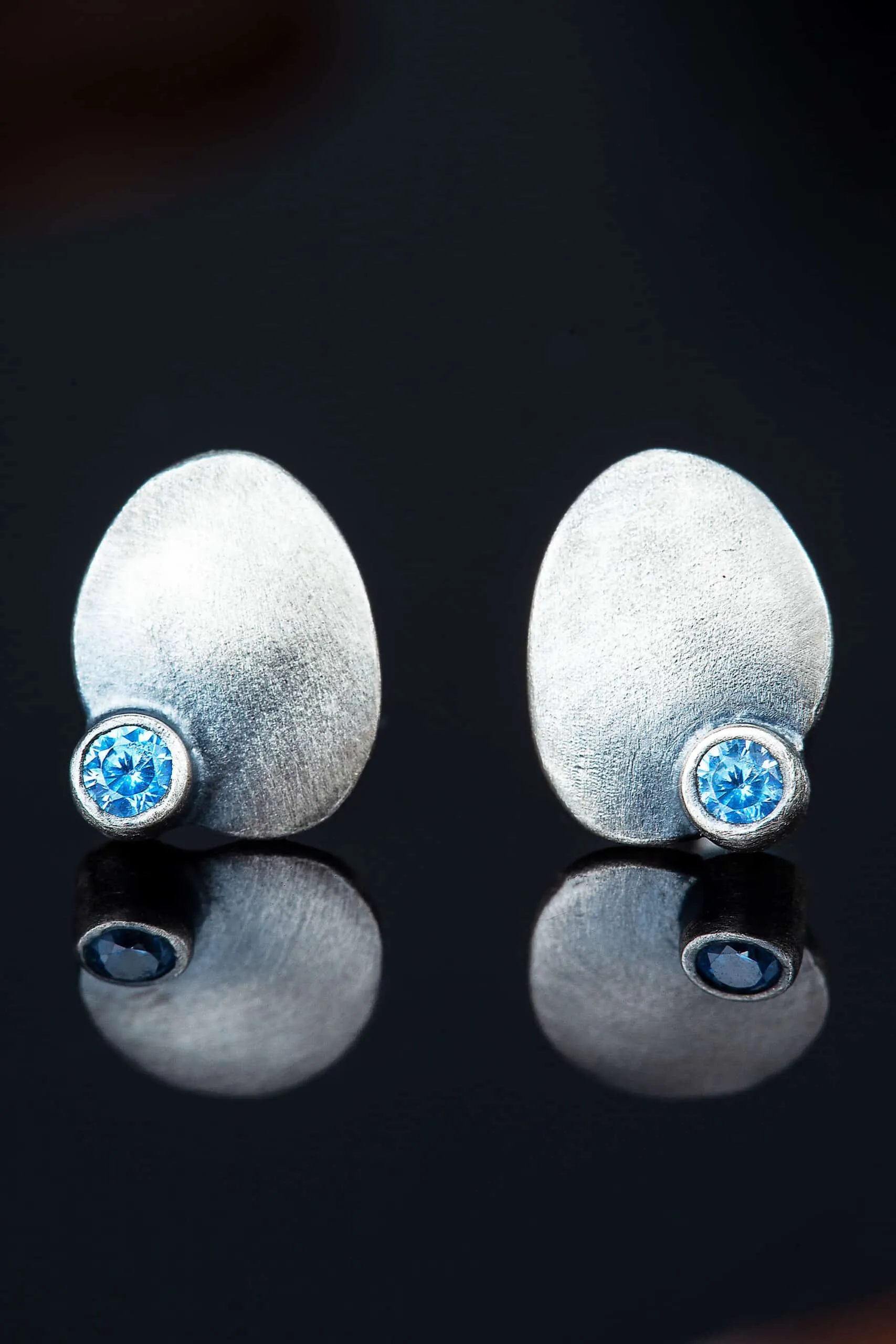 Handmade Jewellery | Oval silver stud earrings with blue zircon gallery 1