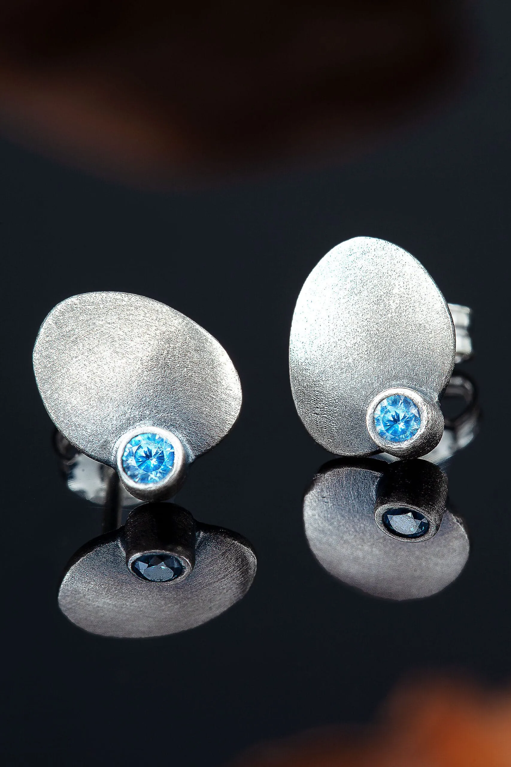 Handmade Jewellery | Oval silver stud earrings with blue zircon gallery 2